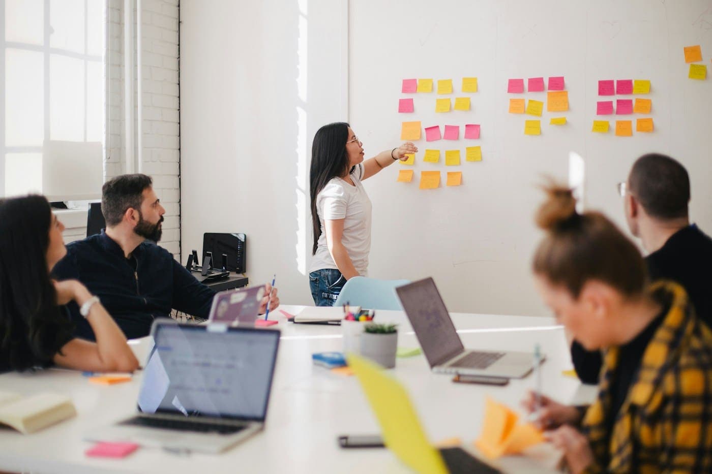 Strategy workshop with sticky notes on a whiteboard during a business planning session