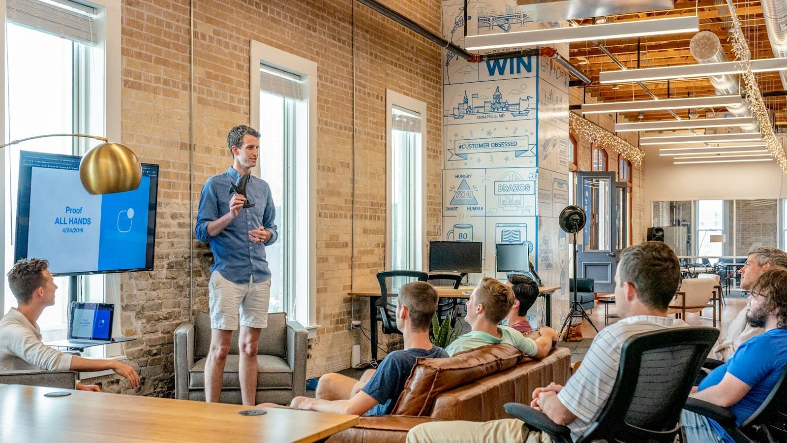Project planning presentation to a team in an open-plan office